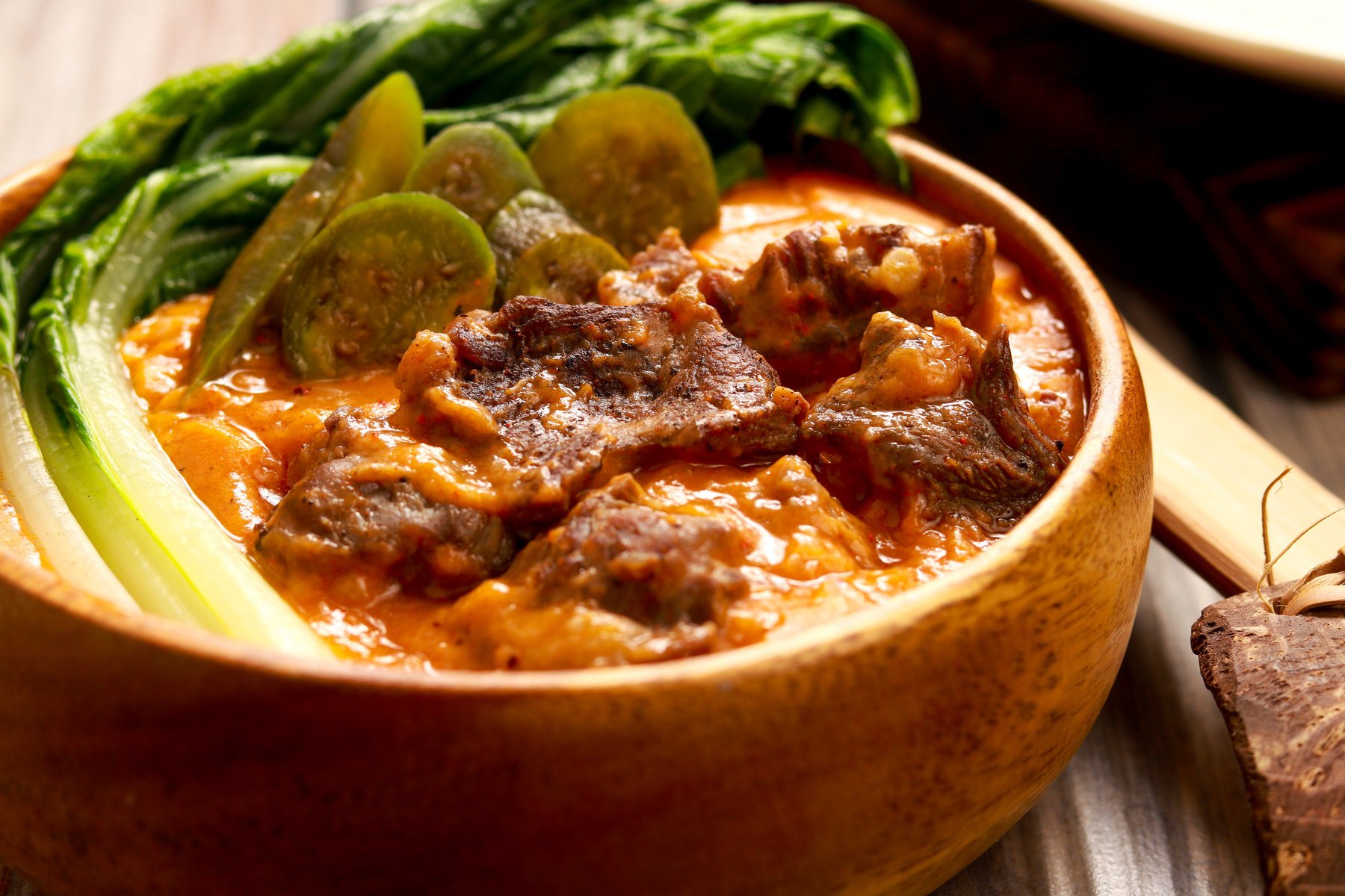 Oxtails in Peanut Gravy. Filipino flavor. Kare-Kare on brown bowl.